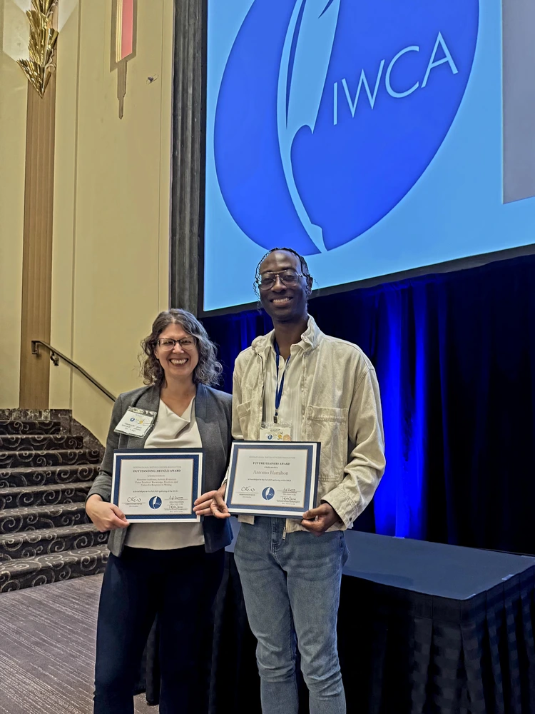 A picture of Carolyn Wisnewski and Antonio Hamilton holding their awards.